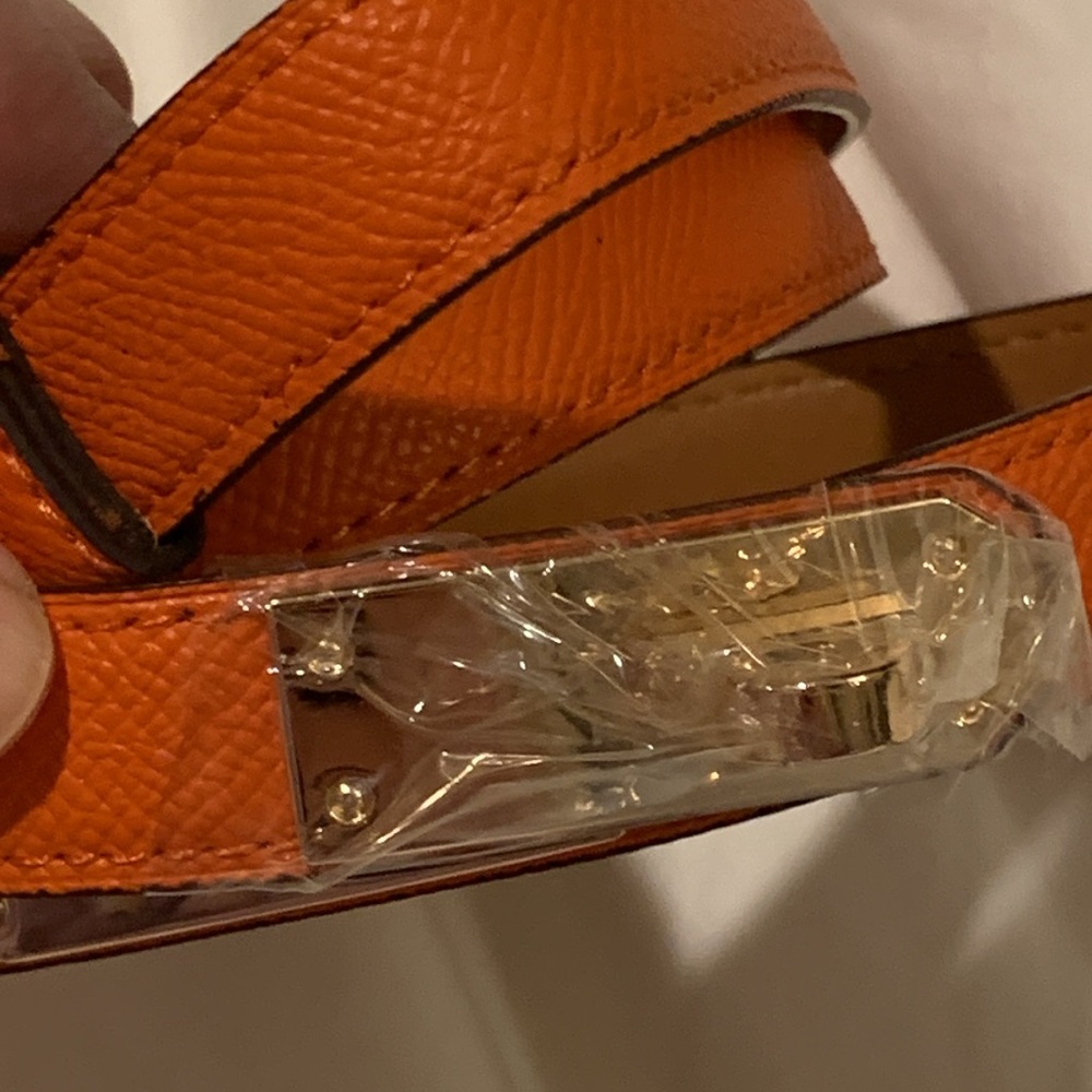 - Brand new thin famous bright orange belt with golden brand new sealed closure